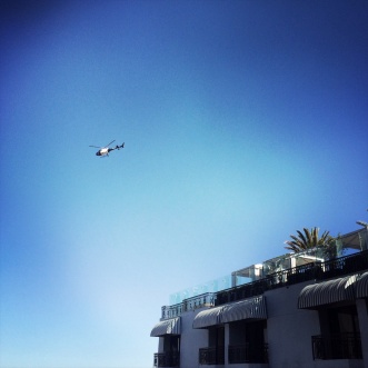 Police chopper circling the rooftop pool